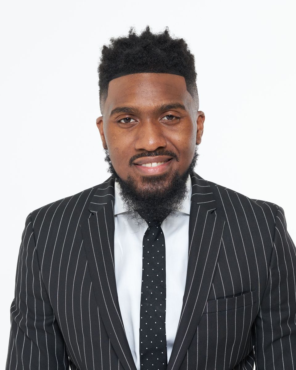 Jahleel Spence in a pinstripe suit and dotted tie